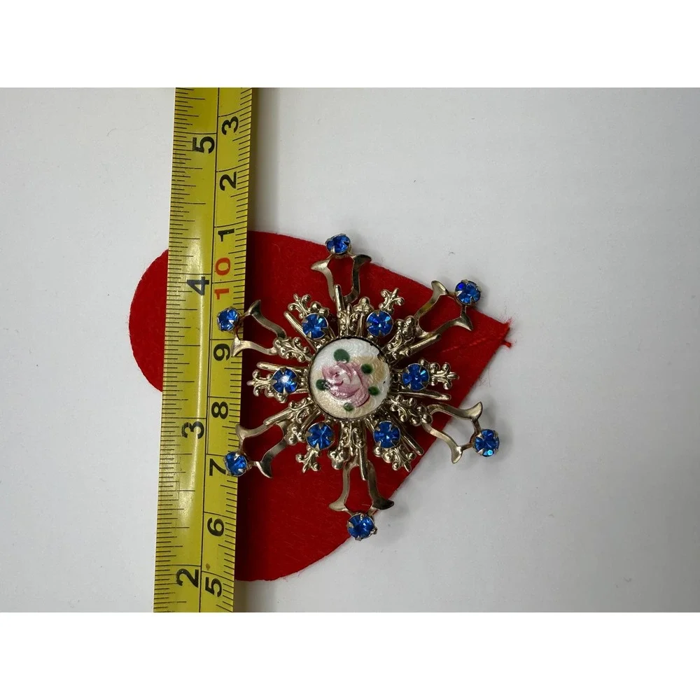 Gold-toned rhinestone starburst brooch floral enamel design blue rhinestones.‎